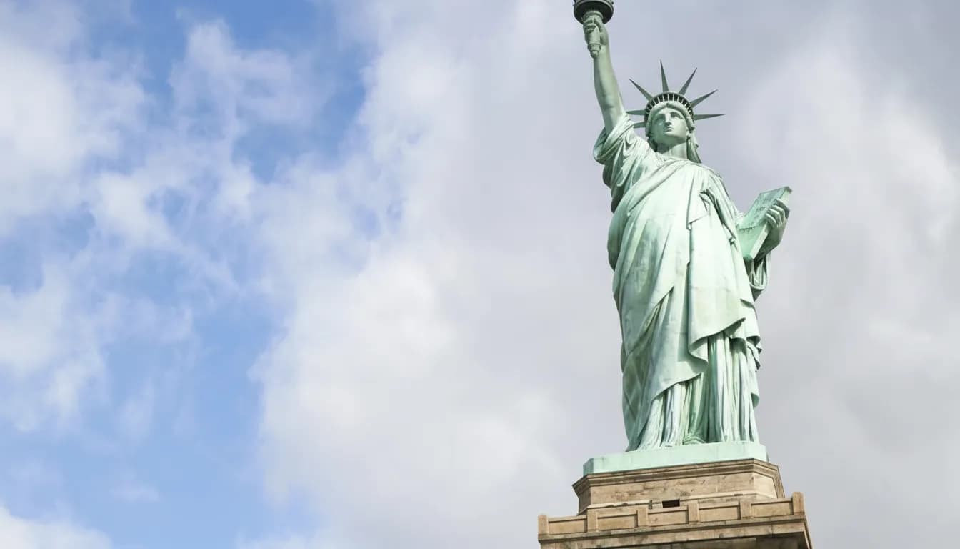 Statue of Liberty against blue sky with clouds