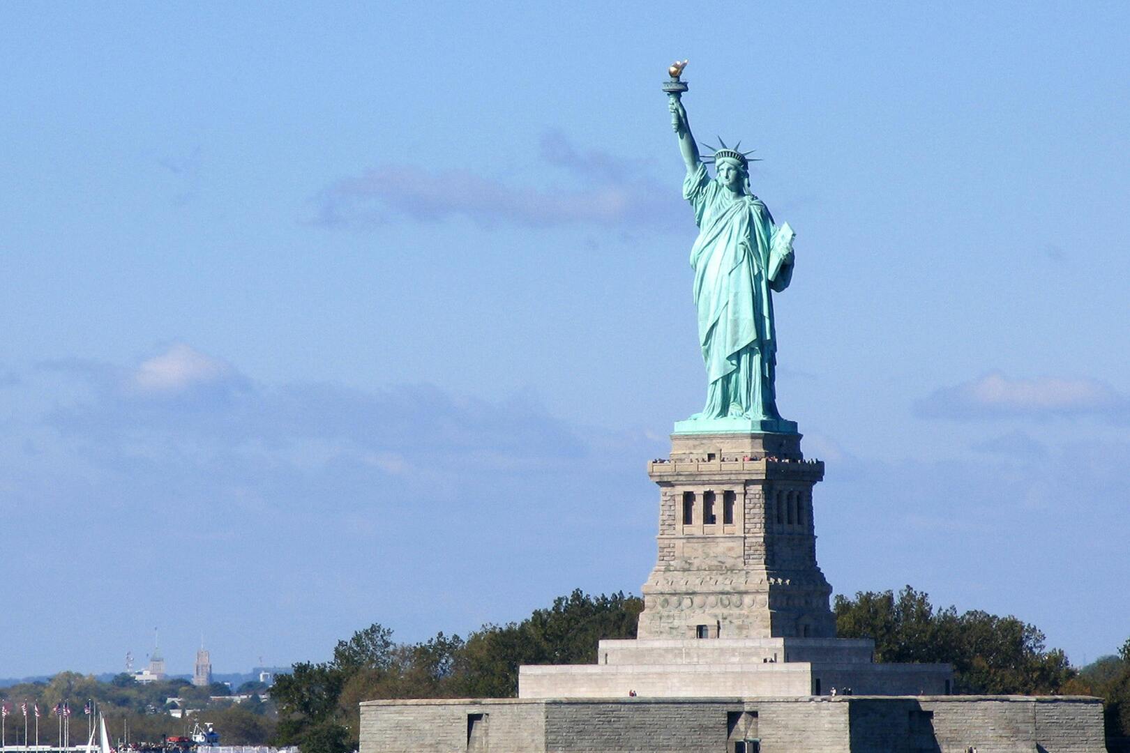 Statue of Liberty entrance with ferry and Liberty Island views